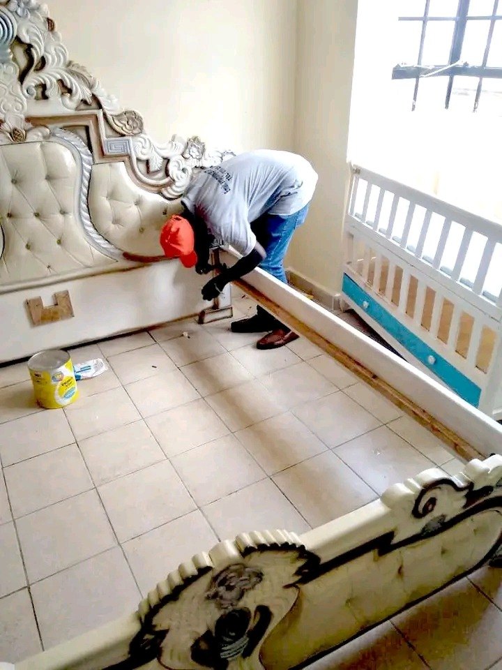 Mover rolling and wrapping a large carpet for transport