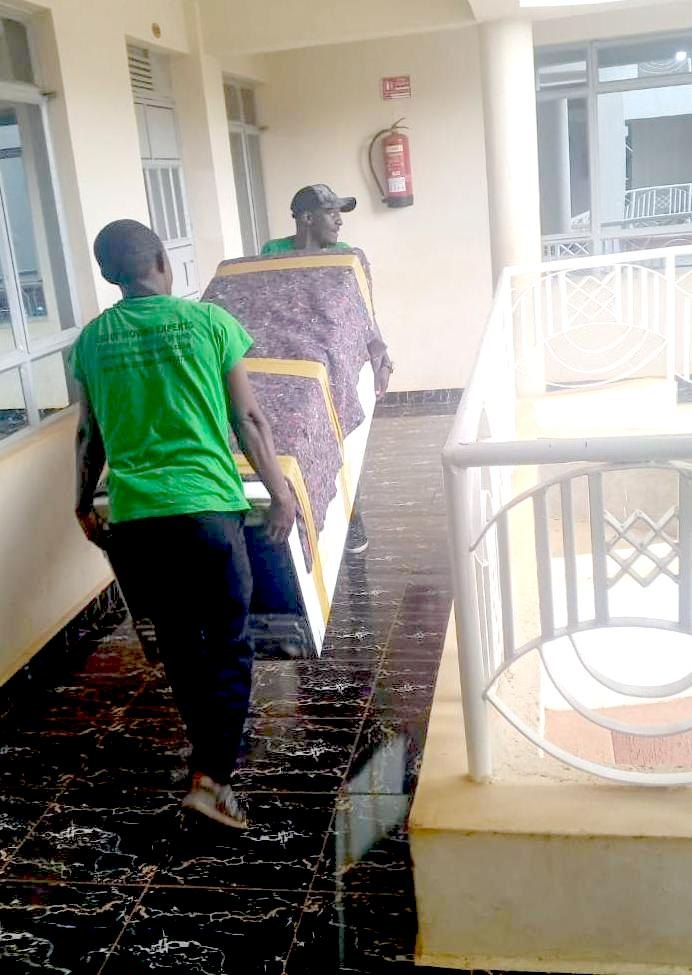 Movers carefully carrying furniture down a staircase