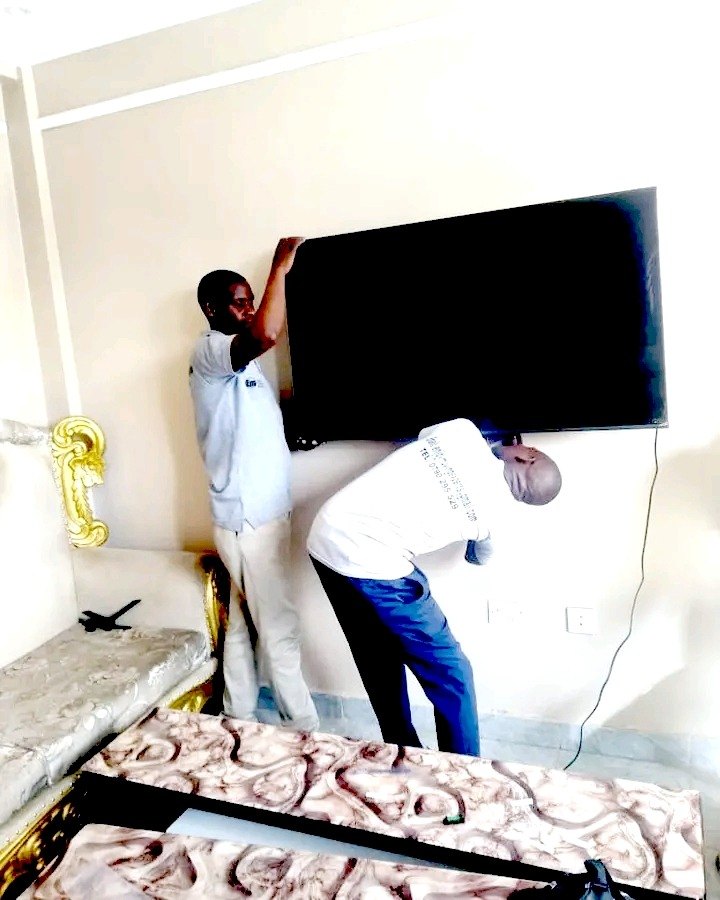 Technician mounting a flat-screen TV on the wall